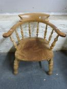 An elm seated captain's chair with turned spindles,