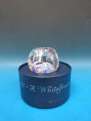 A Whitefriars glass paperweight with faceted top and sides,