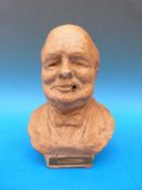 A table lighter in the form of a bust of Winston Churchill,