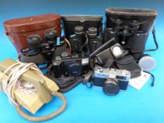 Three pairs of cased binoculars and various camera equipment