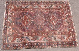 A rug with geometric design on a red ground (156cm x 118cm)