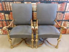 A pair of William and Mary style giltwood upholstered armchairs