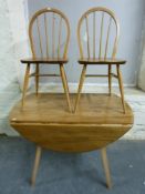 An Ercol light elm table and six chairs