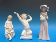 Three Nao figures: a lady with a puppy,