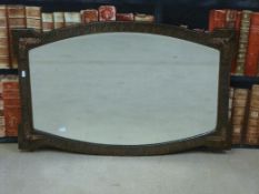An Arts and Crafts style mirror in beaten copper style,