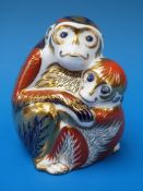 A Royal Crown Derby paperweight in the form of a monkey with her baby