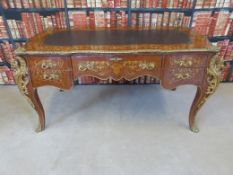 A Louis XV style kingwood style desk fitted central drawer flanked by two drawers to each side,