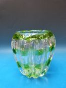 A glass control bubble vase of lobed form with green spiralling decoration,