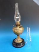 A Duplex brass oil lamp on painted ceramic base