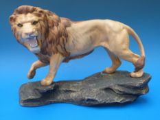 A Beswick lion on a rock