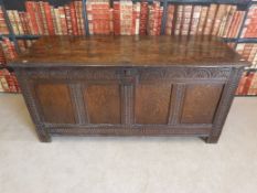 A large 18thC carved oak four-panelled coffer raised on four simple square legs (W151, D61,