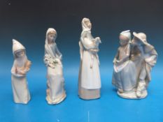 A group of four Lladro figures comprising a courting couple, a shepherdess,