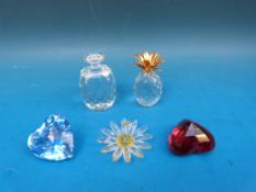 Five Swarovski crystal paperweights one a ring holder in the form of a flower.