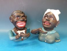 Two replica money boxes formed as heads