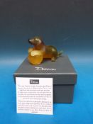 Daum glass puppy on yellow glass ball, signed to the base Daum France (9cm long,