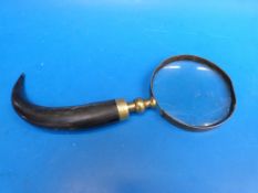 A large magnifier with horn handle
