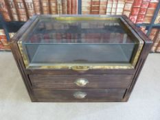 A haberdashery shop counter top display cabinet with lift up glazed top with brass surround  and