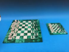 Two malachite chess boards with associated pieces