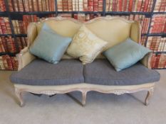 A French limed oak six legged sofa