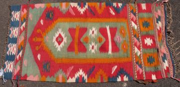 Three large kilim rugs and two square rugs (largest 195 x 109cm)