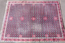 An Arts and Crafts carpet/rug with repeated stylized tulip pattern of William Morris/ Donegal