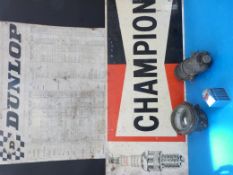 A metal Dunlop garage sign together with a Champion example,