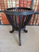 A wooden ebonised jardinere holder of open basket form (diameter 36cm,