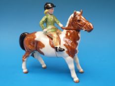 A Beswick girl on skewbald pony