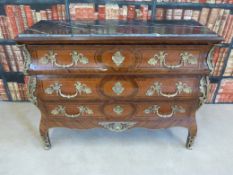 A Louis XV style chest of three drawers with inlaid crossbanding and line inlay with gilt mounts