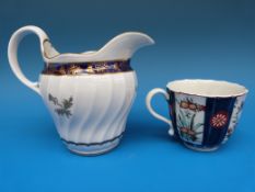 A Worcester wrythen moulded cream jug with thistle motif and an early Worcester teacup (jug 11cm
