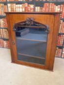 A 19thC mahogany glazed corner cupboard with carved floral pediment and shaped edging