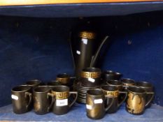 A large quantity of black and gold Portmeirion pottery,