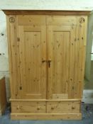 A pine wardrobe with two drawers below (W146, D55,