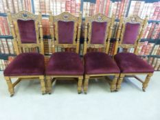 A set of four carved oak upholstered dining chairs
