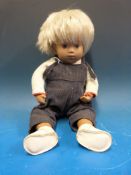 A 1960s Sasha doll of a baby with painted features, short blonde hair and jointed limbs,