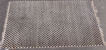 A black and white chequerboard design rug (150 x 84cm) together with another of black and white