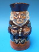 A late 19thC Doulton Lambeth Toby clutching two bags of money No. 8572 (15.