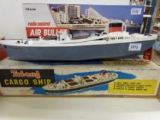A boxed Tri-ang cargo ship MS Ocean Merchant with clockwork movement together with another electric