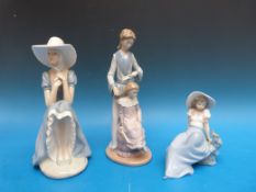 Three Nao figures comprising mother and daughter and two seated girls in bonnets (tallest 29cm)