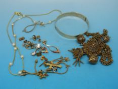 A collection of gold earrings, filigree pendant,