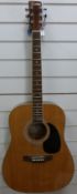 An Encore acoustic guitar with six steel strings,