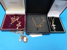 Two silver necklaces, a yellow metal necklace,