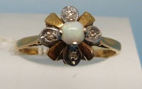 An yellow metal ring set with three opals marked 18ct and alternating diamonds (size R)