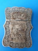 A Chinese shaped white metal filigree card case with floral design in relief
