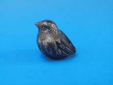 A silver pin cushion in the form of a chick