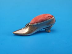 A silver pin cushion modelled as a ladies shoe (Ldn) maker AN