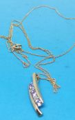 A 9ct gold pink sapphire and diamond pendant and chain