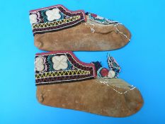 A pair of North American Indian moccasins with extensive embroidered beadwork decoration