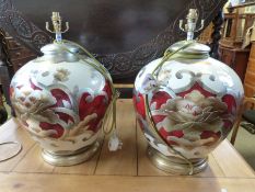 A pair of large decorative table lamps with large silk shades,