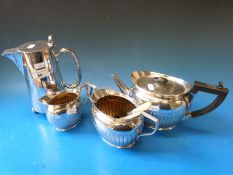 A Hukin & Heath three piece silver plated tea set together with another plated hot water jug